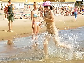 girls peeing on a beach